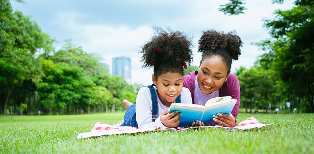 woman_and_girl_reading_outdoors_optimized.jpg
